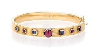 A 14 Karat Yellow Gold, Ruby and Sapphire Bangle Bracelet, 7.90 dwts.