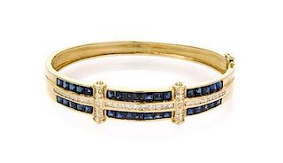 A 14 Karat Yellow Gold, Diamond and Sapphire Bangle Bracelet, 13.30 dwts.