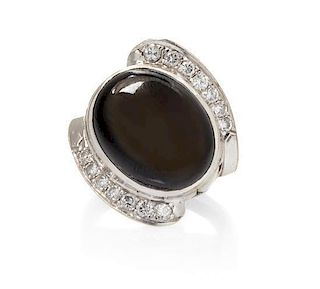 * A White Gold, Black Star Sapphire and Diamond Ring, 7.45 dwts.