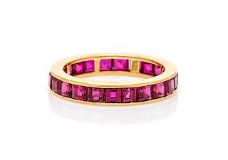 * An 18 Karat Yellow Gold and Ruby Eternity Band, 2.10 dwts.