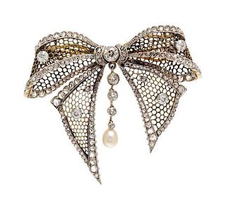 A Platinum Topped Gold, Diamond and Pearl Bow Brooch, 9.80 dwts.