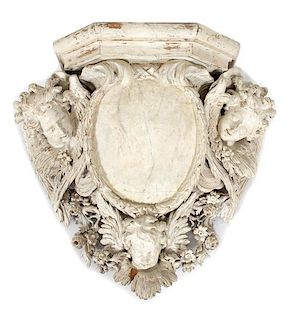 A Continental Carved and White Painted Armorial Wall Bracket Height 32 1/2 x width 35 1/2 inches.