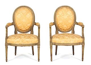 A Pair of Louis XVI Style Carved and Painted Fauteuils Height 35 inches.