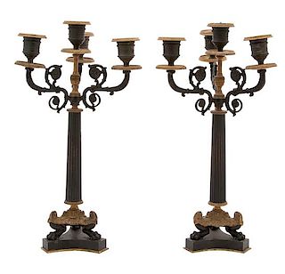 A Pair of French Empire Style Ebonized and Gilt Bronze Candelabra Height 15 1/4 x diameter 8 inches.