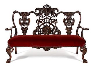 An Irish Chippendale Style Mahogany Settee Height 48 1/2 x width 72 1/2 x depth 25 inches.