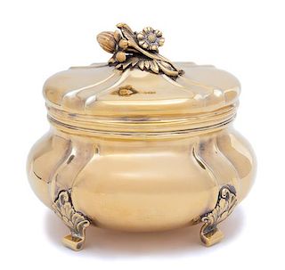 A Danish Vermeil Silver Covered Box, Tiffany & Co., NY, 20th Century, of oval form with floral spray finial; raised on scrolled