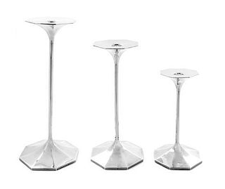 A Set of Three Graduated Italian Silver Candlesticks Height of tallest 11 3/4 inches.