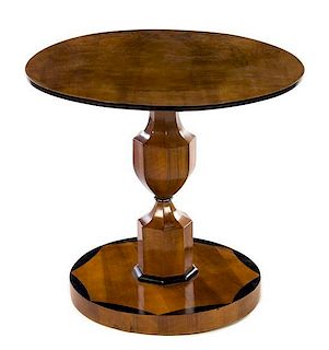 A Biedermeier Parcel Ebonized Burlwood Pedestal Table Height 28 x diameter 31 inches.