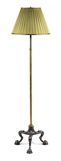 A Neoclassical Steel and Iron Floor Lamp Height overall 60 inches.