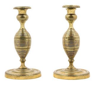 A Pair of Brass Candlesticks Height 8 1/4 inches.