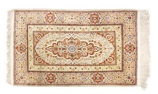 A Persian Wool and Silk Rug 4 feet x 2 feet 6 inches.