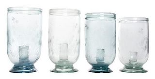 A Set of Four English Etched Glass Candleholders Height of tallest 9 1/2 inches.