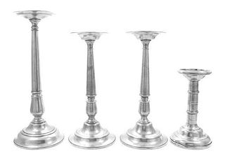 A Collection of Four Pewter Pricket Sticks Height of tallest 20 1/2 inches.