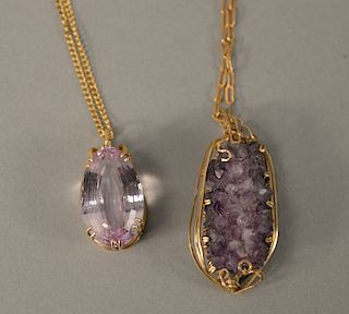 Two large amethysts in 14 karat gold pendant mounts, each on gold plated chains.
