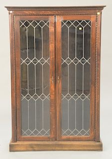 Oak Victorian bookcase with two leaded doors. ht. 59 in., wd. 39 in.