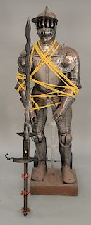 Two piece lot to include a suit of armor, 20th century (ht. 73 in.), and a large sword (lg. 72 in.).