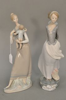 Two Lladro figures, mother and child (ht. 13 1/2 in.) and girl holding book (ht. 14 in.).
