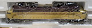 Two Lionel train displays to include Lionel Golden Arrow Congressional Special 8272, both on track in display case with wood base, i...
