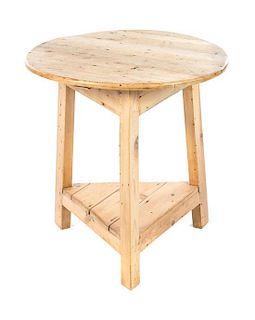 A Contemporary Pine Occasional Table Height 27 3/4 x diameter 26 inches.