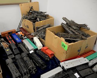 Large group of Lionel trains and track parts to include four train sets with four engines, sixteen cars, etc.