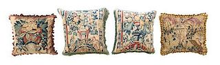 A Set of Four Tapestry Upholstered Pillows Width of widest 19 inches.
