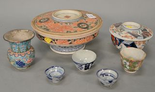 Group of Chinese porcelain to include large covered porcelain bowl, a covered cup, three small cups, and an enameled vase.