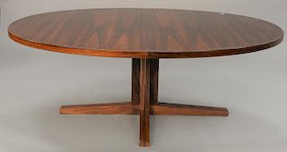 Danish modern oval rosewood table with two leaves (19 1/2 in.) and pads, on pedestal base. ht. 28 in., top: 75'' x 48''