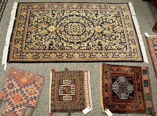 Twelve small Oriental throw rugs, mats, and two bags. 1'1" x 1'2" to 3'3" x 4'11"