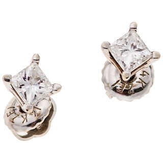 A diamond 14K white gold pair of stud earrings.