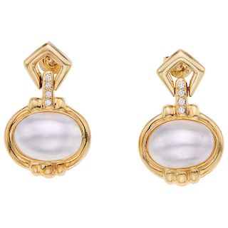 A half-pearl and diamond 18K and 14K yellow gold pair of earrings.