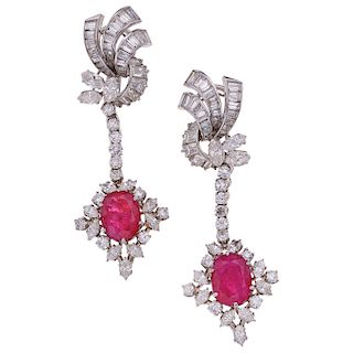 A ruby and diamond platinum and palladium silver pair of earrings.
