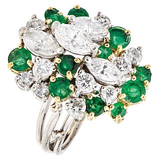 A diamond and emerald 18K white and yellow gold ring.