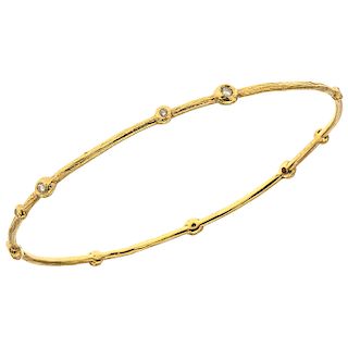 A diamond 18K yellow gold bangle bracelet.