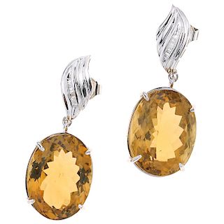 A citrine and diamond 14K white gold pair of earrings.