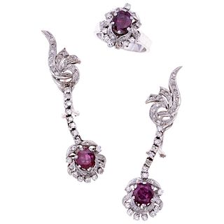 A ruby and diamond palladuim silver ring and pair of earrings set.