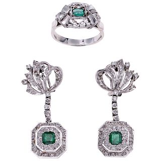 An emerald and diamond palladium silver ring and pair of earrings.