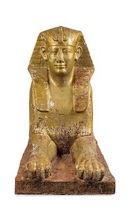 * A Gold-Painted Cast Iron Model of a Sphinx Height 33 x width 19 x depth 59 inches.