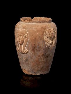 * An Egyptian Terra Cotta Jar with Hathor Height 4 1/4 inches.
