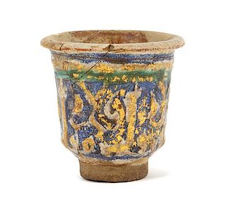 An Islamic Blue, Green and Iridescent Gold Glazed Pottery Cup Height 2 7/8 inches.