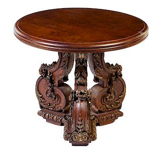 An Italian Carved Oak Table Height 26 3/4 x diameter of top 31 inches.
