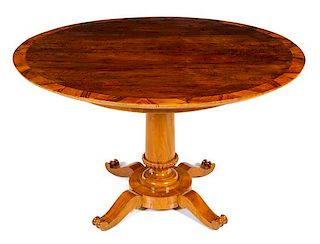 A Biedermeier Walnut Center Table Height 28 1/2 x diameter of top 48 1/2 inches.