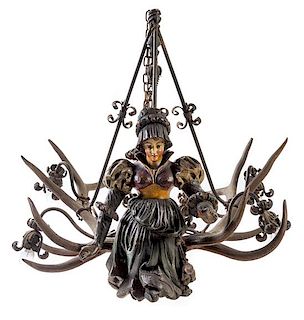 A Swiss Black Forest Carved Wood and Antler Four-Light Chandelier Height 41 x width 44 inches.
