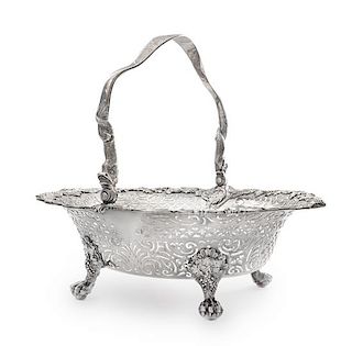 A George II Silver Centerpiece Basket, Thos. Gilpin, London, 1747, the dolphin-form swing handle above the basket with an engrav