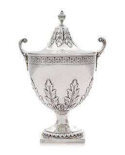 A George III Covered Sugar, Elizabeth Roker, London, 1775, the beaded urn form finial above the acanthus decorated lid, the body