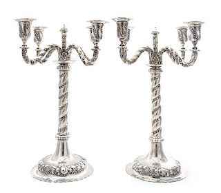 A Pair of German Silver Four-Light Candelabra, Early 20th Century, each central stem issuing four S-scroll candle arms worked to