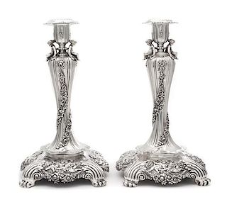 A Pair of American Silver Candlesticks, Tiffany & Co., New York, Circa 1900, each fluted urn form candle cup worked to show flor