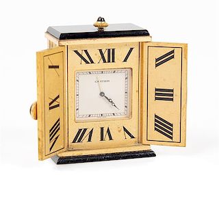 A Miniature French Gilt Metal Desk Clock Height 2 1/8 x width 2 7/8 inches (open).