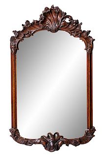 A Rococo Style Carved Walnut Mirror Height 37 1/2 x width 21 inches.