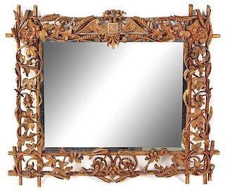A Black Forest Carved Mirror Height 26 x width 29 1/2 inches.