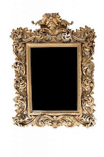 An Italian Rococo Carved Giltwood Mirror Height 50 x width 40 inches.